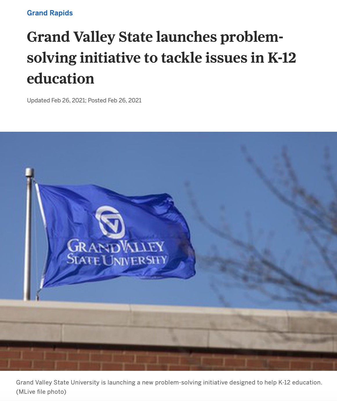 Screenshot of article "Grand Valley State launches problem-solving initiative to tackle issues in K-12 education" with photo of GVSU flag